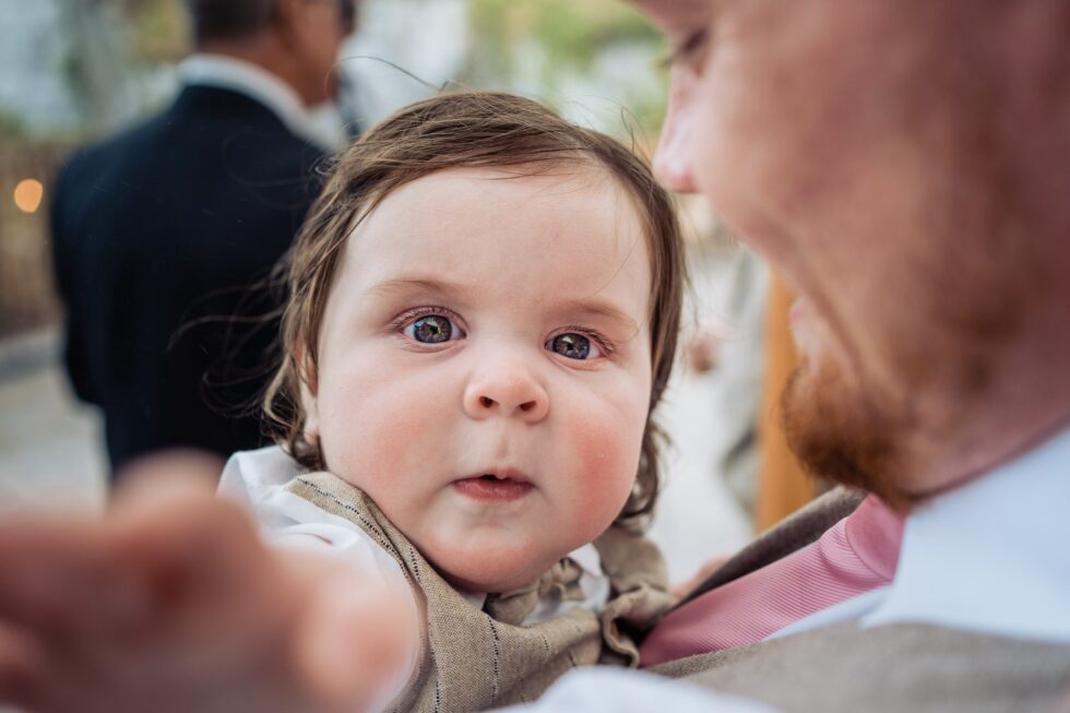 Cute baby at a wedding. Yeti Wedding Photography captures precious family moments.