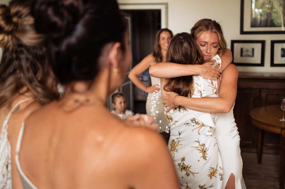 Bridal party hugs at Manoir de Longeveau wedding. Bride hugging bridesmaid. Yeti Wedding Photography Old.