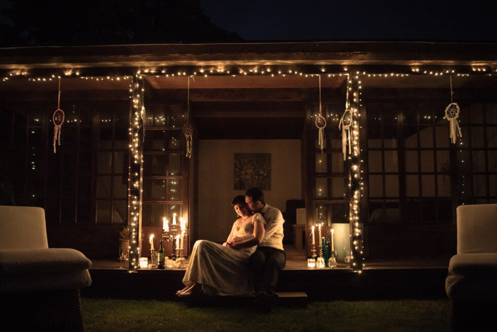 Bride and groom at night, lit by candles and fairy lights. Yeti Wedding Photography Exeter.