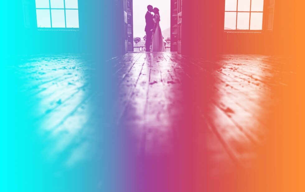 Silhouette of wedding couple kissing in doorway. Colorful Yeti Wedding Photography.
