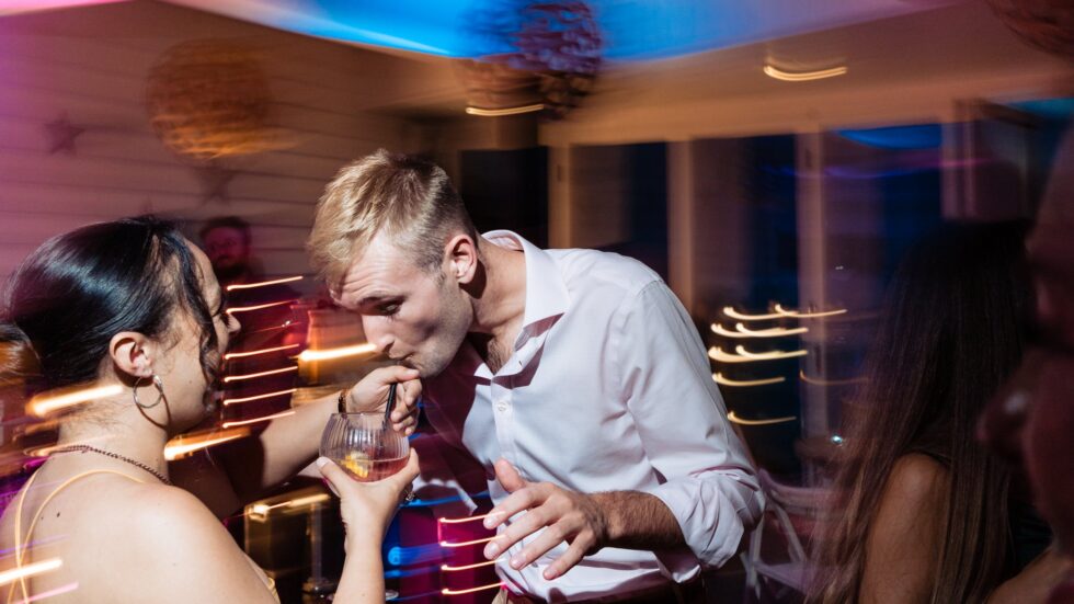 Devon wedding party dancing. Groom shares drink with guest at Yeti Wedding Photography Old reception.