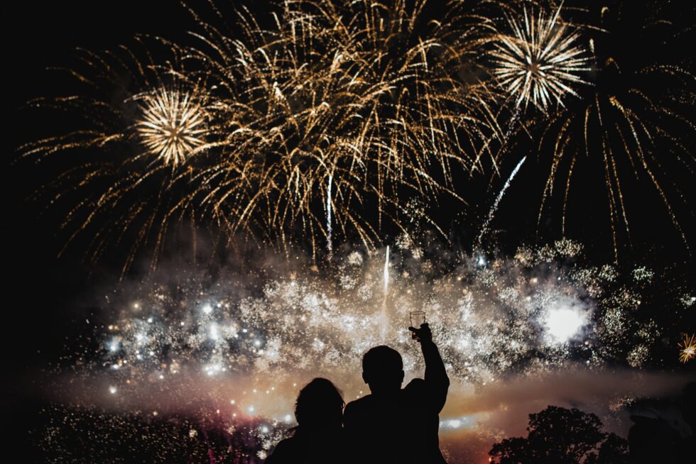 Exeter wedding fireworks display. Bride and groom celebrate with champagne. Yeti Wedding Photography.