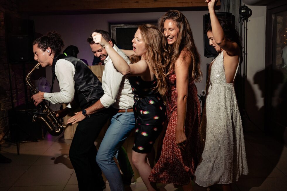 Wedding party at Trevenna Barns. Saxophone player and guests dancing. Yeti Wedding Photography.