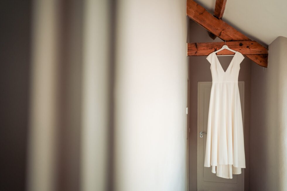 Wedding dress hanging at Trevenna Barns, Cornwall. Yeti Wedding Photography.