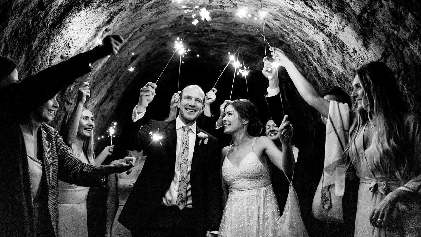 MA-467: Sparkler Wedding Exit MA-467: Bride and groom exit tunnel amid sparkling sparklers at wedding celebration, black and white photo.